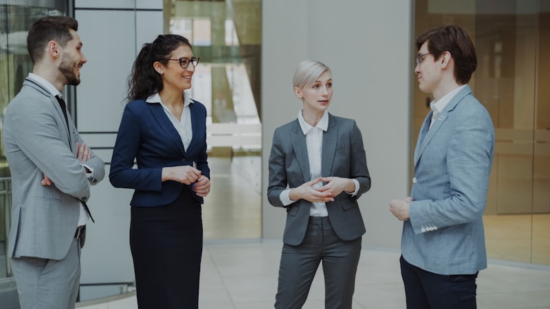 Business professionals conversing in modern office lobby
