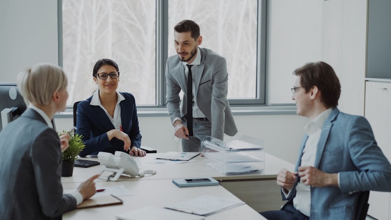 Business professionals collaborating around conference table